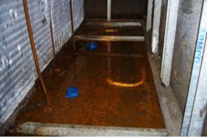 leaking condensate pan with brown sludge