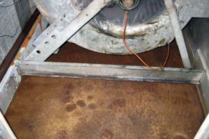 Condensate pan with corrosion and standing water at government building in Atlanta, GA
